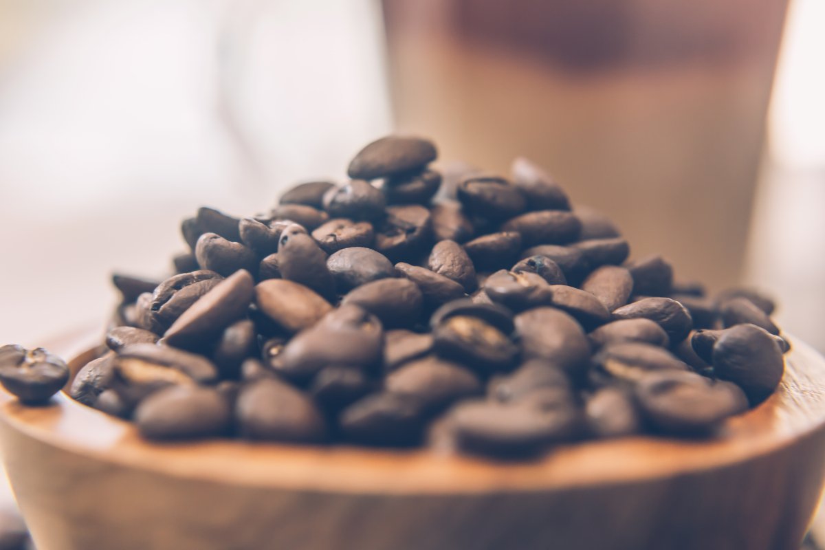 heaped medium roast coffee beans in a wooden bowl in Sydney